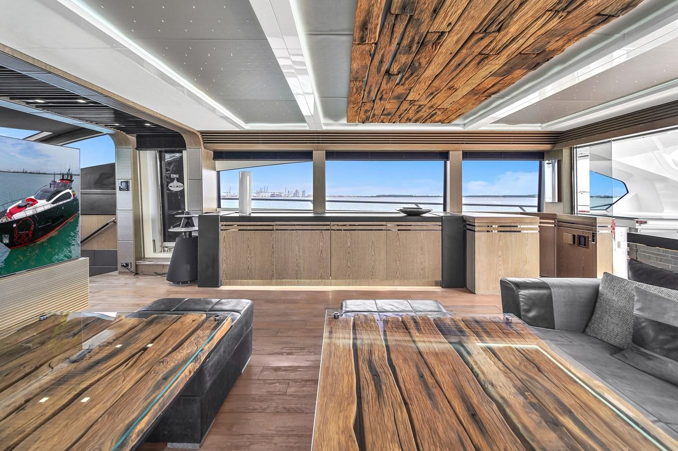 a room with a couch and a large window aboard SUNSEEKER 115 SPORT YACHT  Yacht for Sale