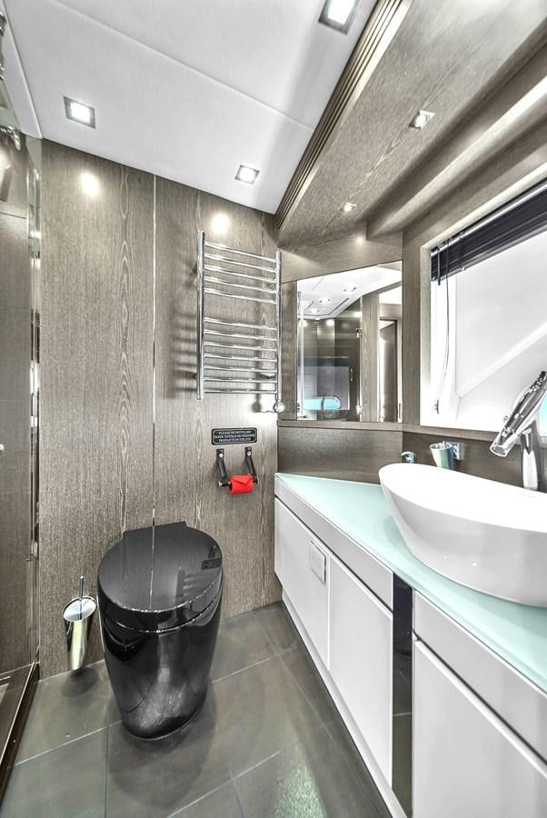 a bathroom with a sink and a large mirror aboard SUNSEEKER 115 SPORT YACHT  Yacht for Sale