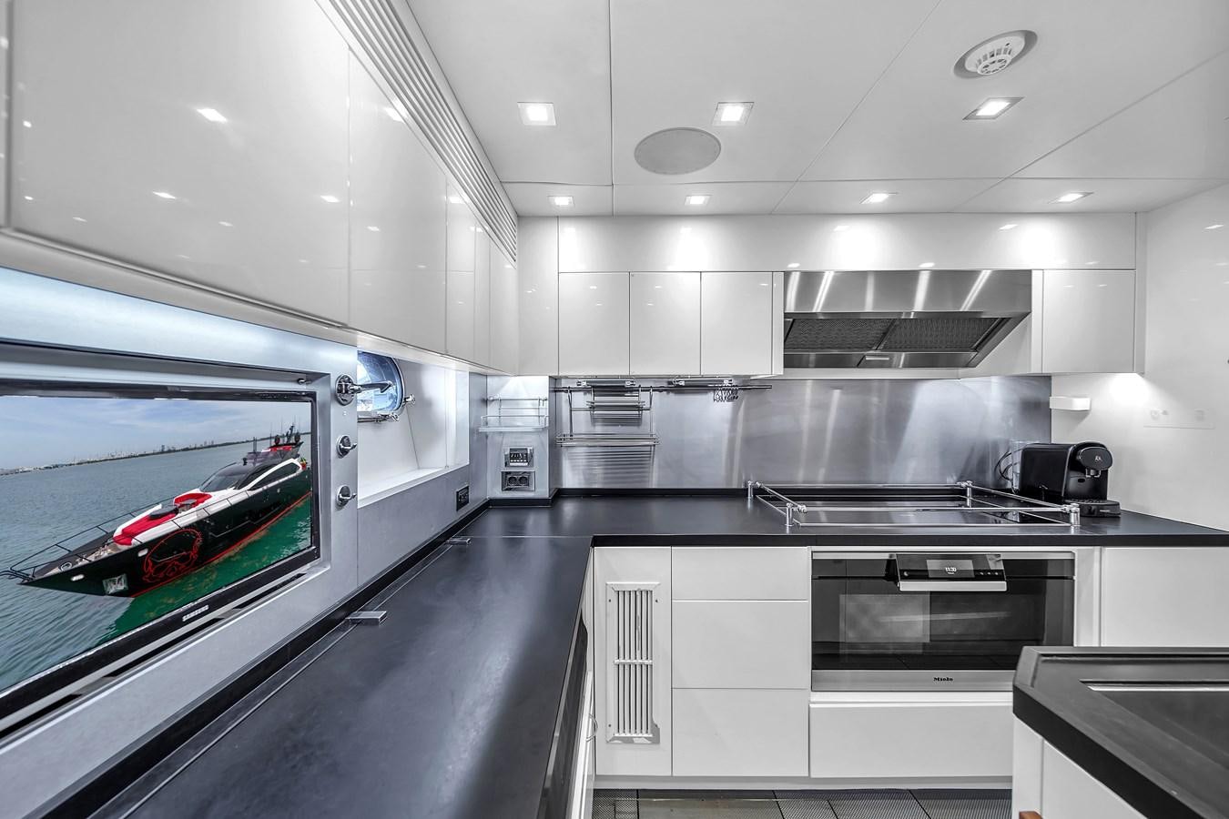 a kitchen with a large window aboard SUNSEEKER 115 SPORT YACHT  Yacht for Sale