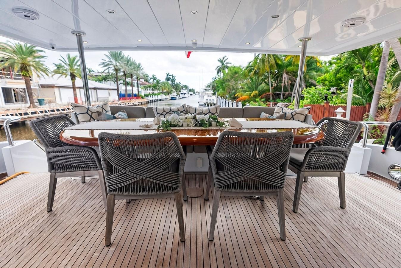 a patio with chairs and tables aboard TORTUGA Yacht for Sale