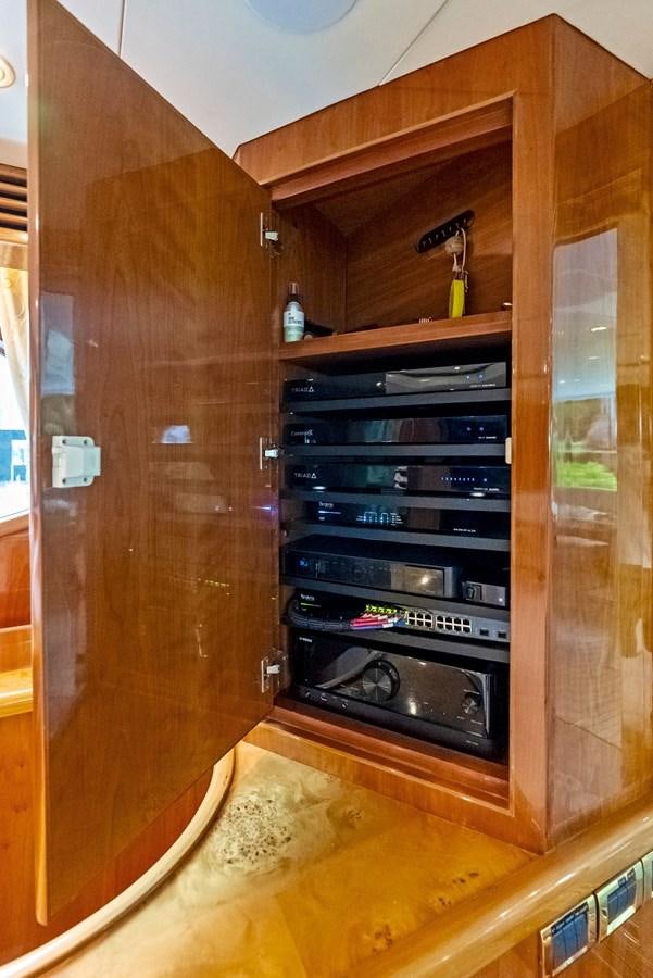 a wooden cabinet with a black shelf aboard TORTUGA Yacht for Sale