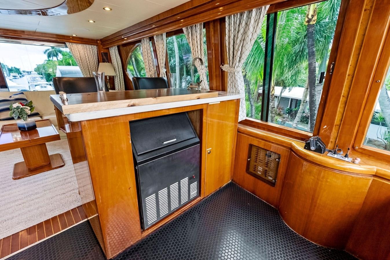 a room with a tv and a table aboard TORTUGA Yacht for Sale