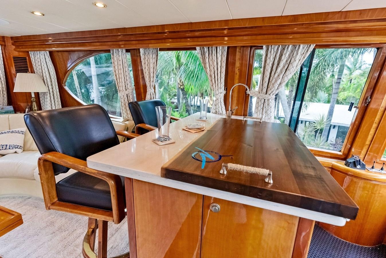a table with chairs and a couch aboard TORTUGA Yacht for Sale