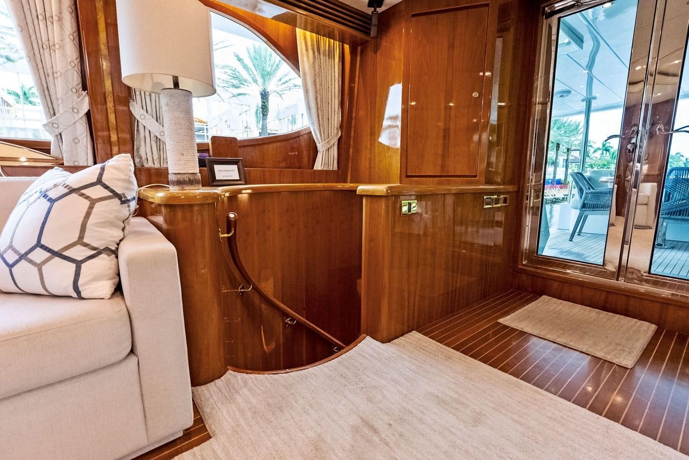 a living room with a wood table aboard TORTUGA Yacht for Sale