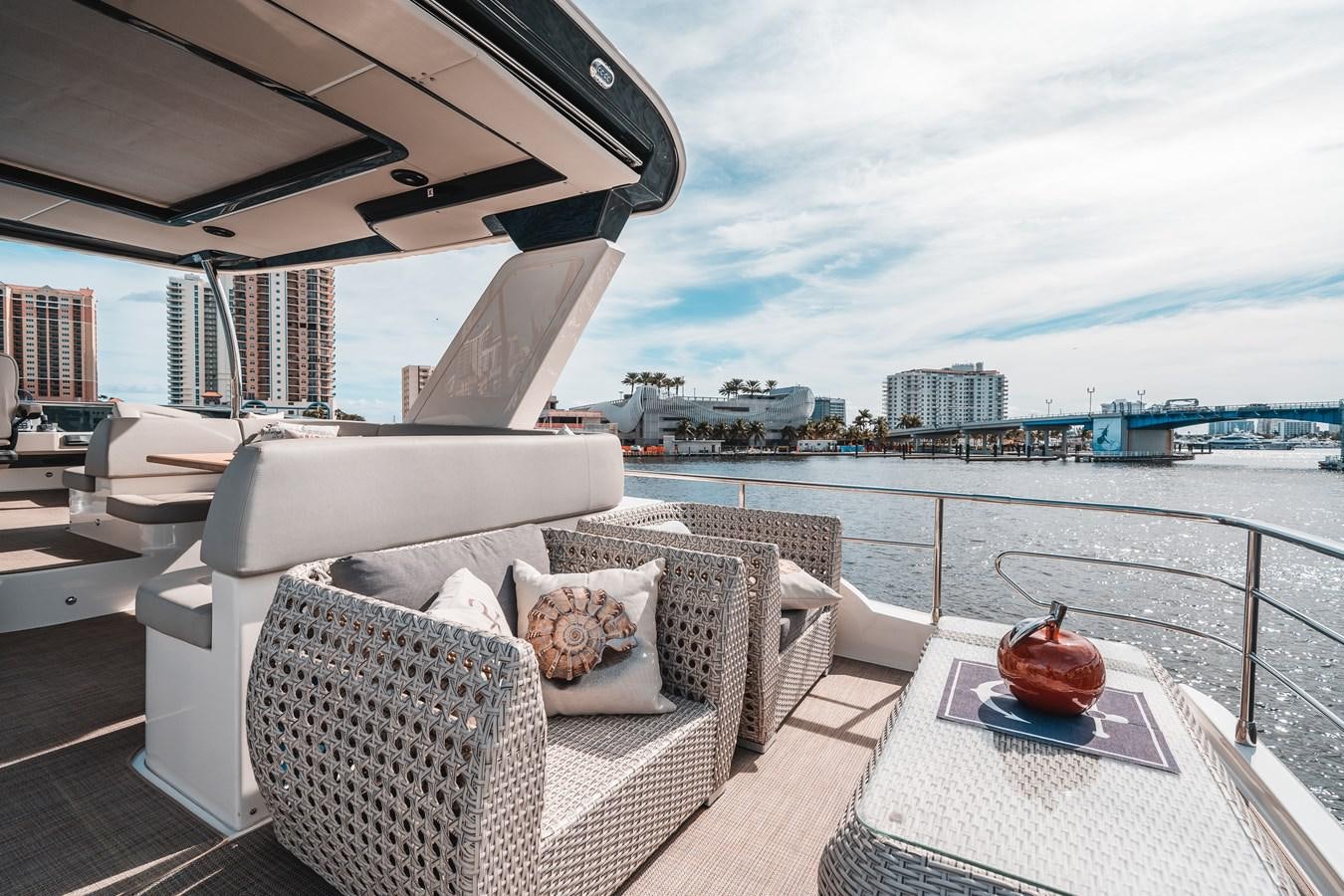 a rooftop view of a patio with a large body of water and a large building with a red aboard ABSOLUTE 68 NAVETTA Yacht for Sale