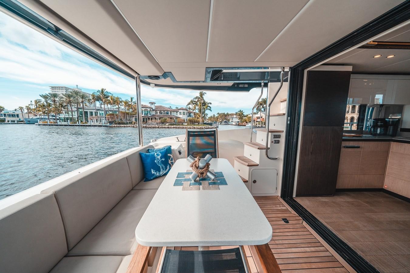 a room with a table and a view of the water aboard ABSOLUTE 68 NAVETTA Yacht for Sale