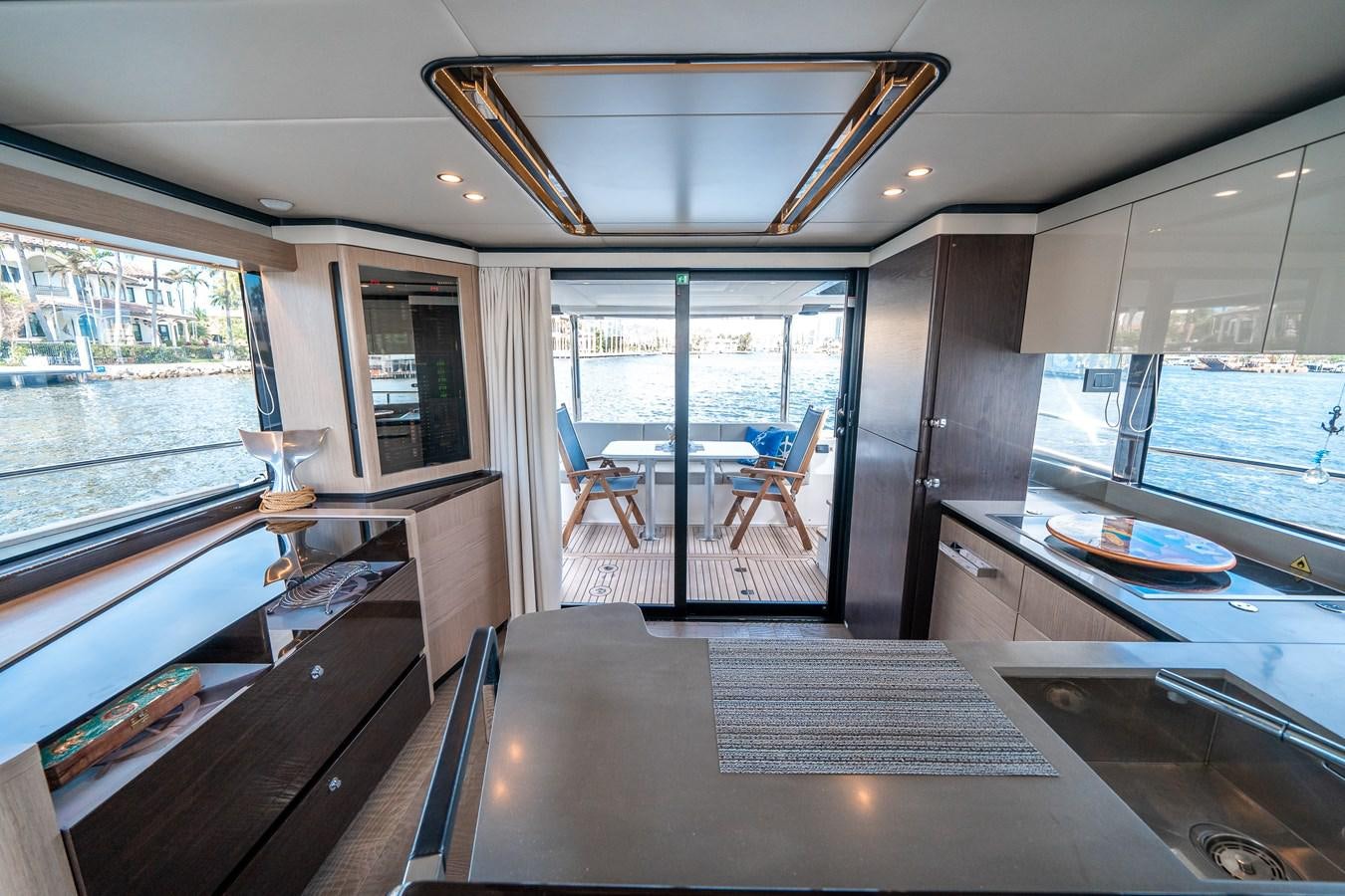 inside of a building with a large window and a table and chairs aboard ABSOLUTE 68 NAVETTA Yacht for Sale