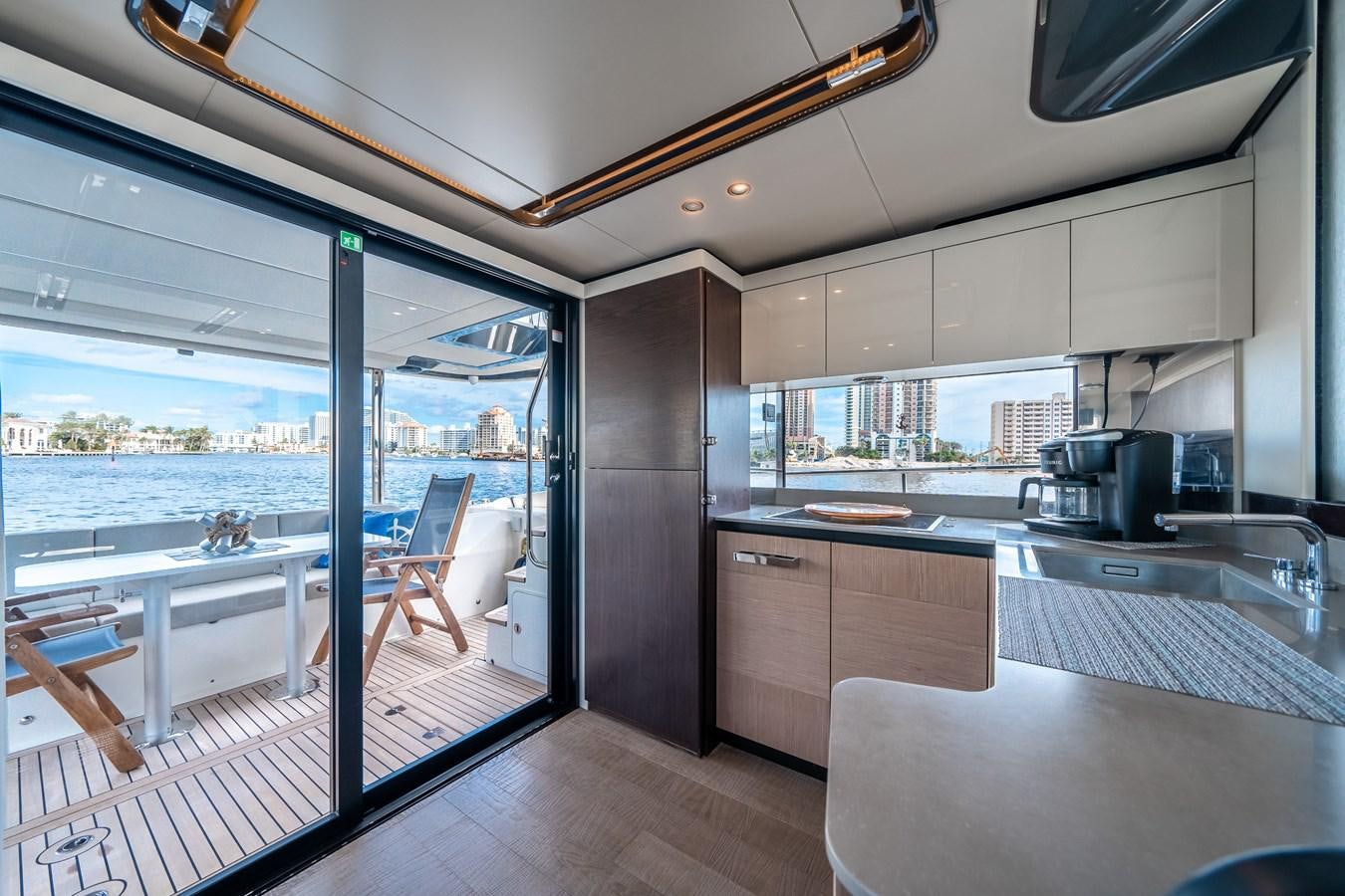 a kitchen with a view of the water and the deck aboard ABSOLUTE 68 NAVETTA Yacht for Sale