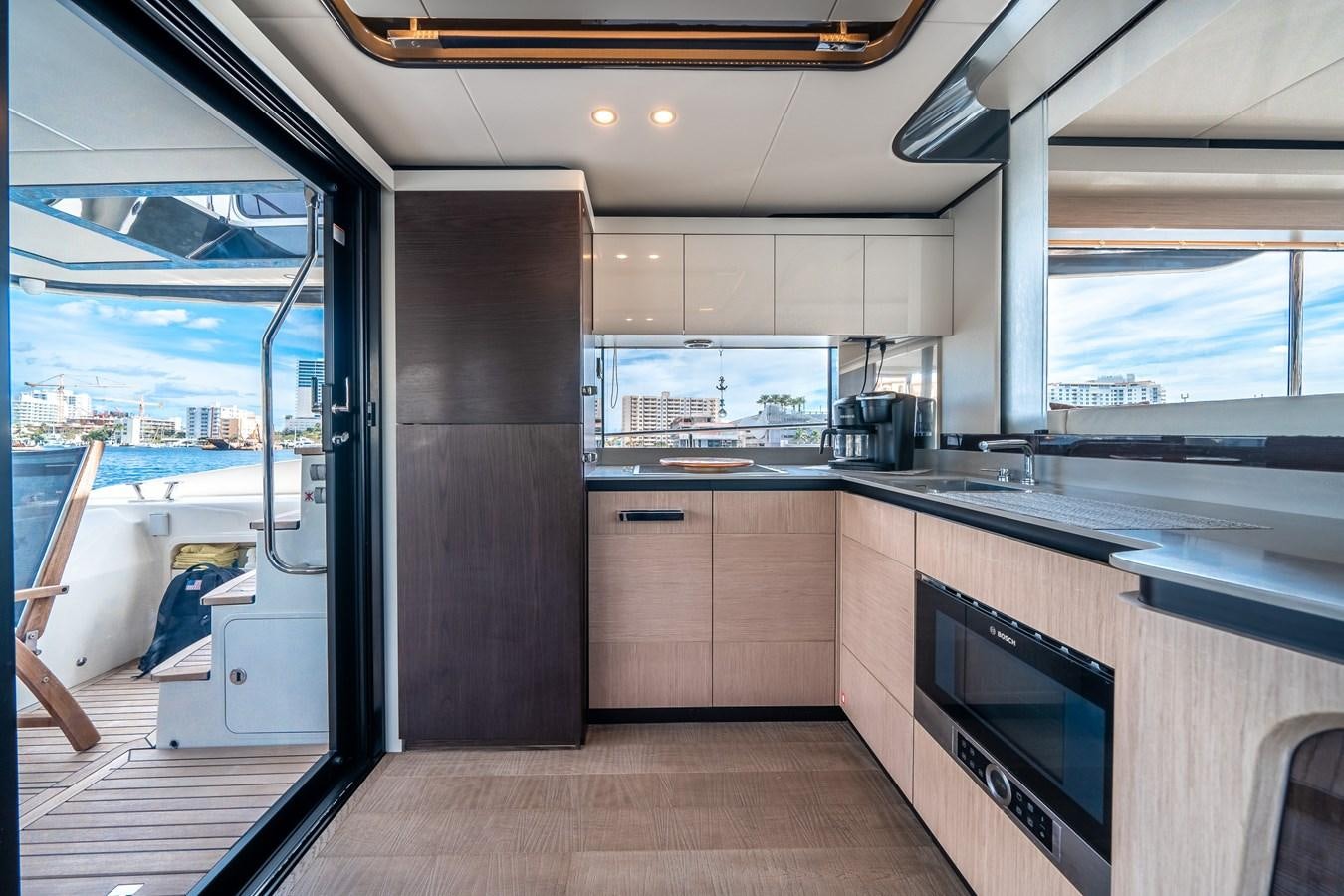 a kitchen with a sliding glass door aboard ABSOLUTE 68 NAVETTA Yacht for Sale