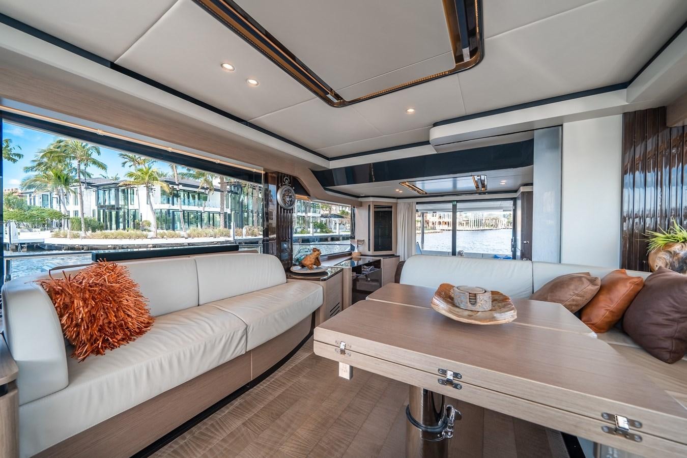 a living room with a table and couches aboard ABSOLUTE 68 NAVETTA Yacht for Sale