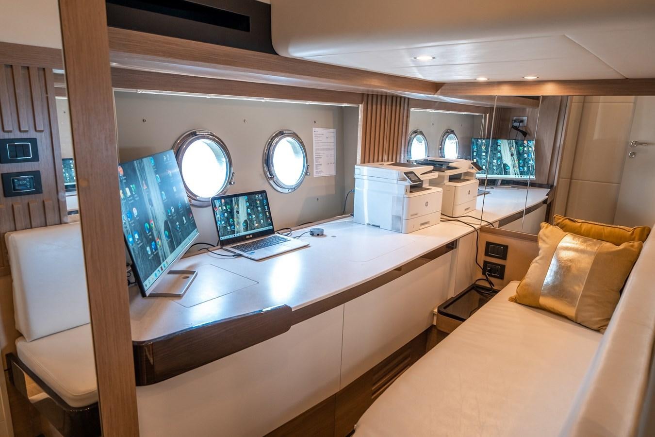 a room with a desk and a bed aboard ABSOLUTE 68 NAVETTA Yacht for Sale