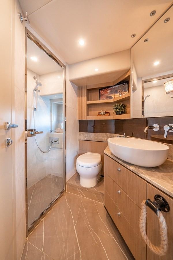 a bathroom with a sink and toilet aboard ABSOLUTE 68 NAVETTA Yacht for Sale