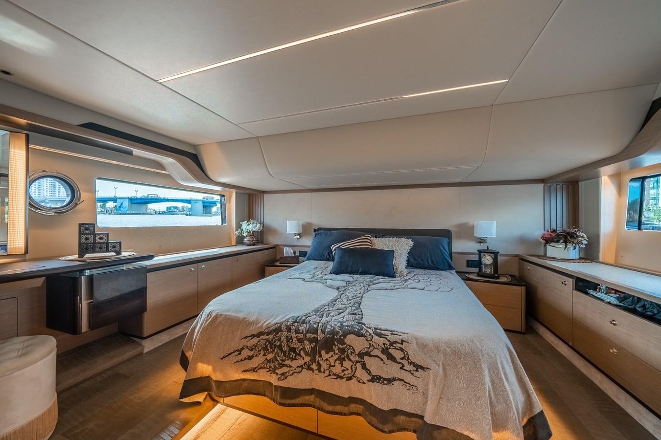 a bedroom with a bed and desk aboard ABSOLUTE 68 NAVETTA Yacht for Sale