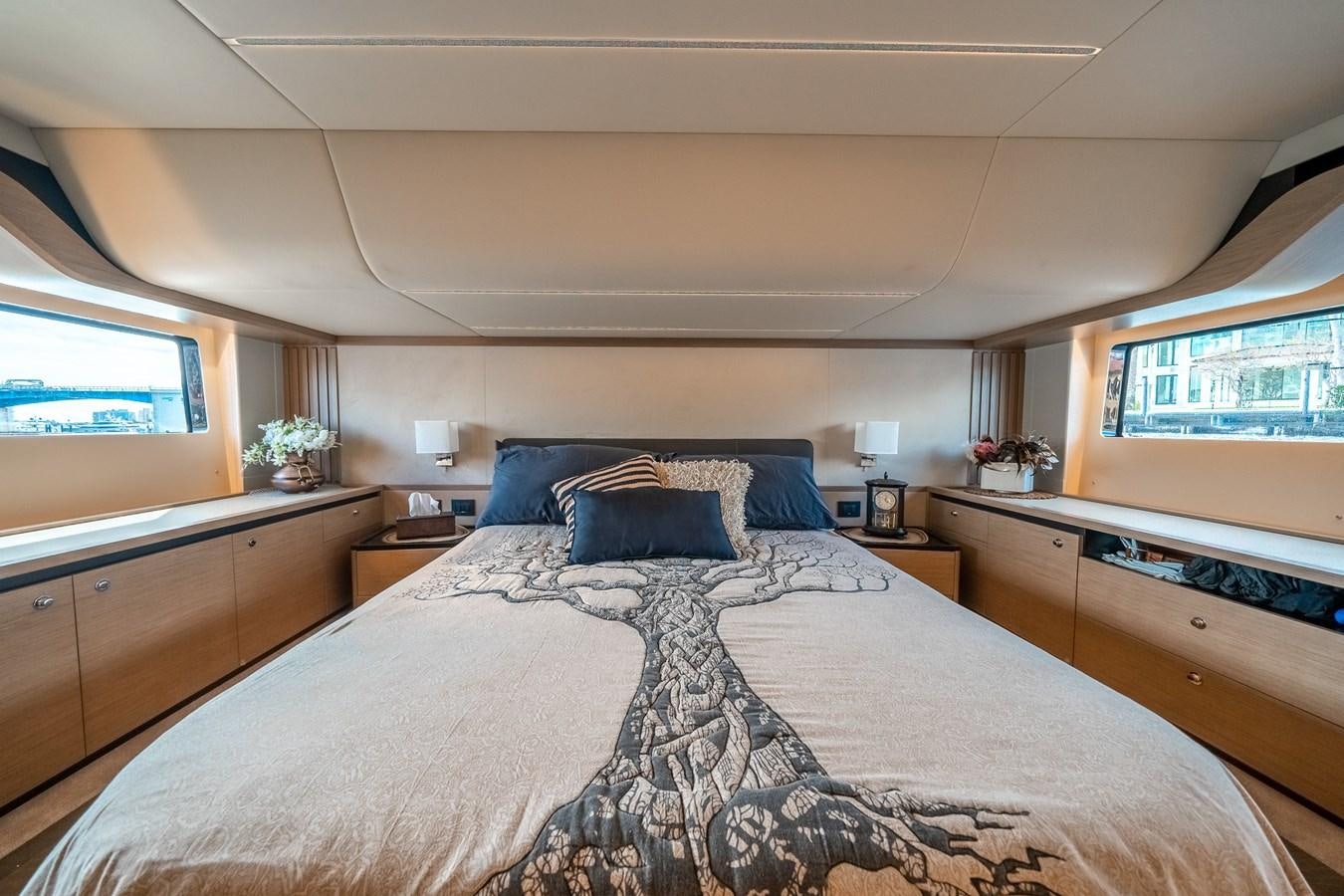 a bedroom with a bed and a window aboard ABSOLUTE 68 NAVETTA Yacht for Sale