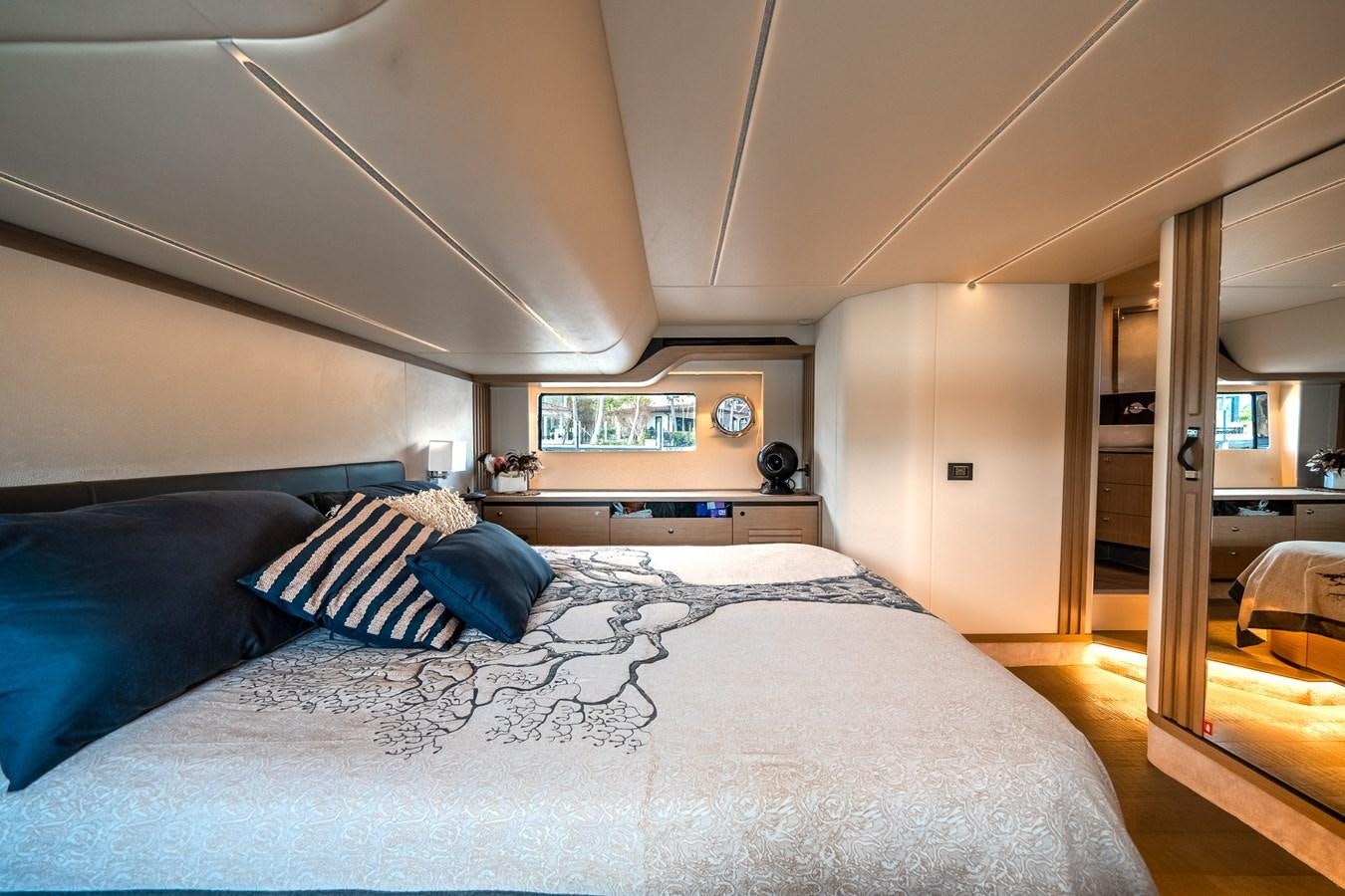 a bedroom with a bed and a large mirror aboard ABSOLUTE 68 NAVETTA Yacht for Sale