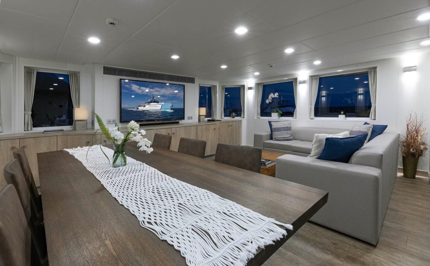 a large living room with a large bed and a flat screen tv aboard SHADOW Yacht for Sale