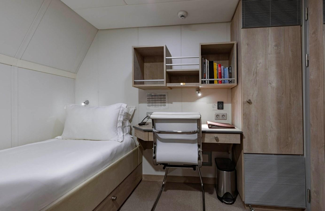 a room with a bed and a desk aboard SHADOW Yacht for Sale