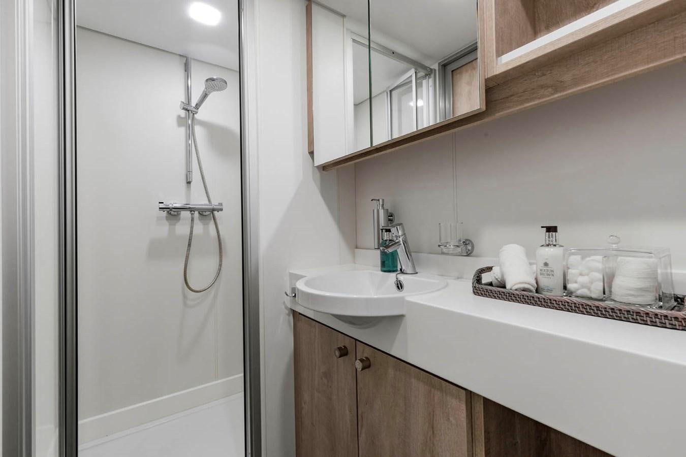 a bathroom with a sink and a shower aboard SHADOW Yacht for Sale