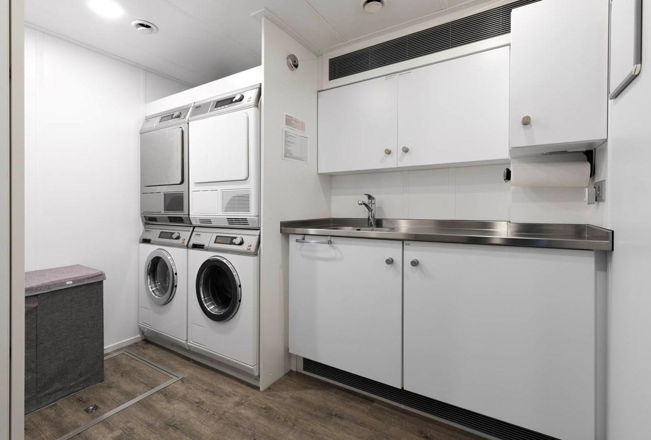 a washer and dryer in a kitchen aboard SHADOW Yacht for Sale