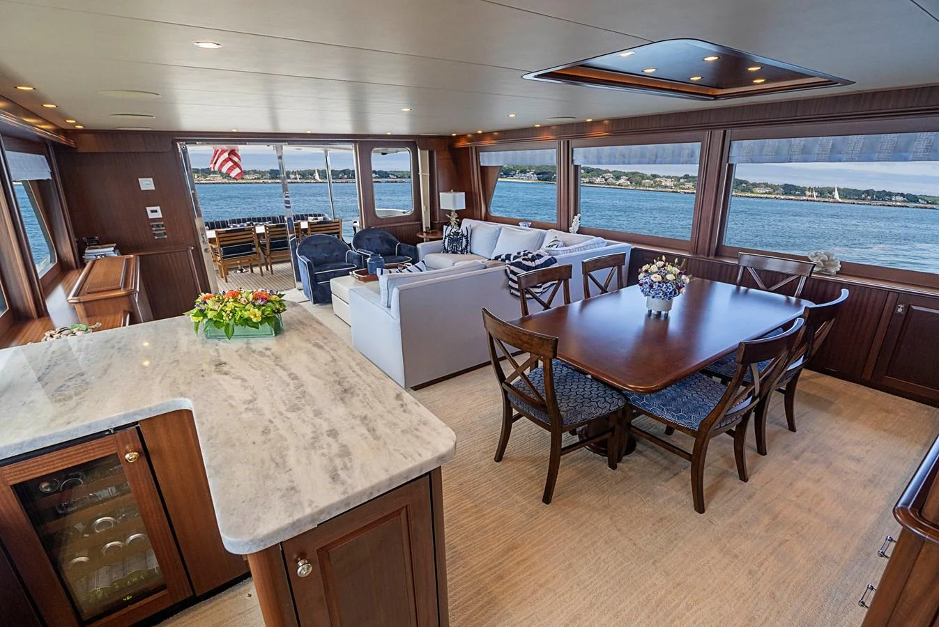 a large living room with a large table and chairs aboard TRANQUILITY Yacht for Sale