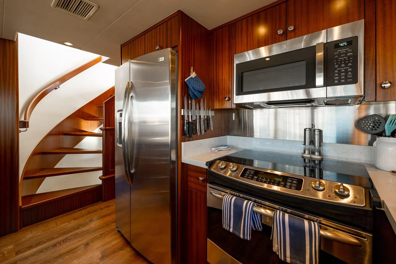 a kitchen with a stainless steel refrigerator aboard TRANQUILITY Yacht for Sale
