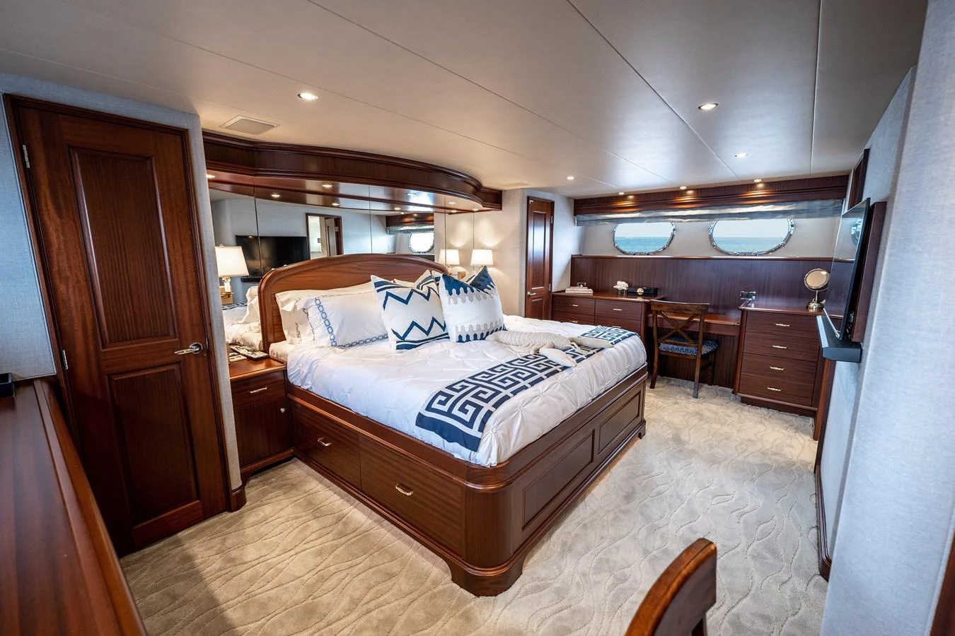 a bedroom with a bed and a desk aboard TRANQUILITY Yacht for Sale