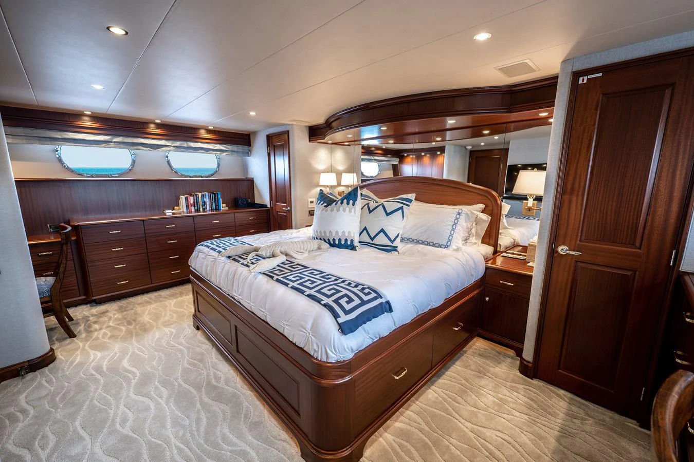 a bedroom with a bed and a desk aboard TRANQUILITY Yacht for Sale