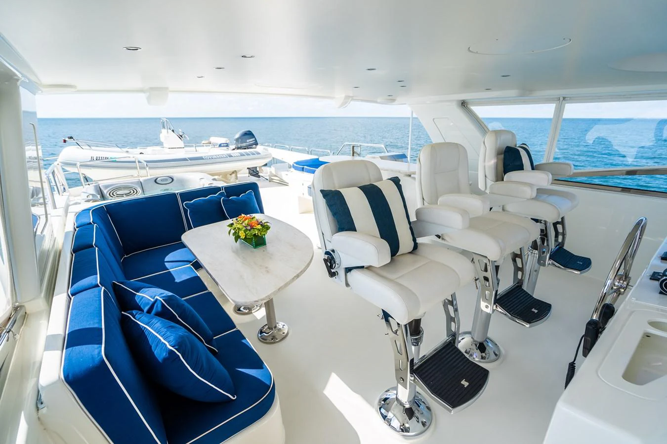 a room with a table chairs and a view of the ocean aboard TRANQUILITY Yacht for Sale