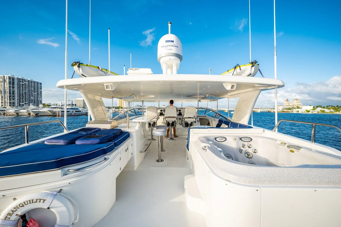 a couple of people walking on a dock towards a large white plane aboard TRANQUILITY Yacht for Sale