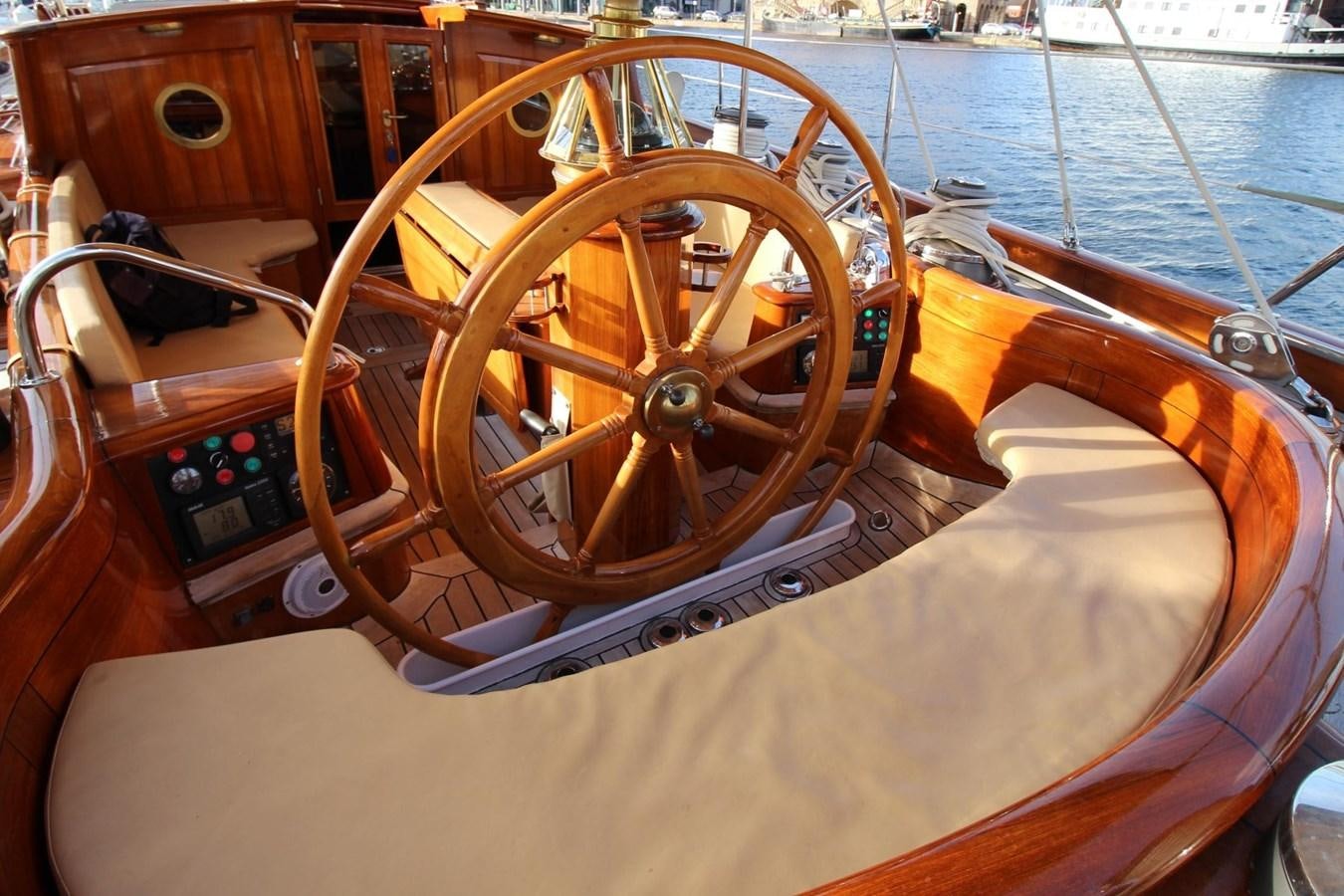 a wooden steering wheel on a boat aboard BRAVEHEART OF SARK Yacht for Sale
