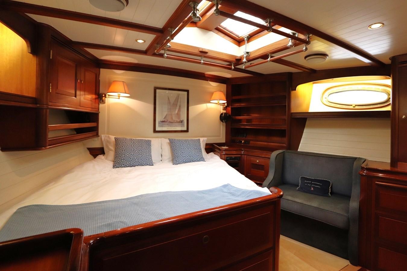 a bedroom with a bed and a couch aboard BRAVEHEART OF SARK Yacht for Sale