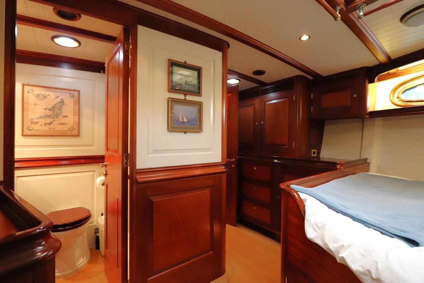 a bedroom with a bed and cabinets aboard BRAVEHEART OF SARK Yacht for Sale