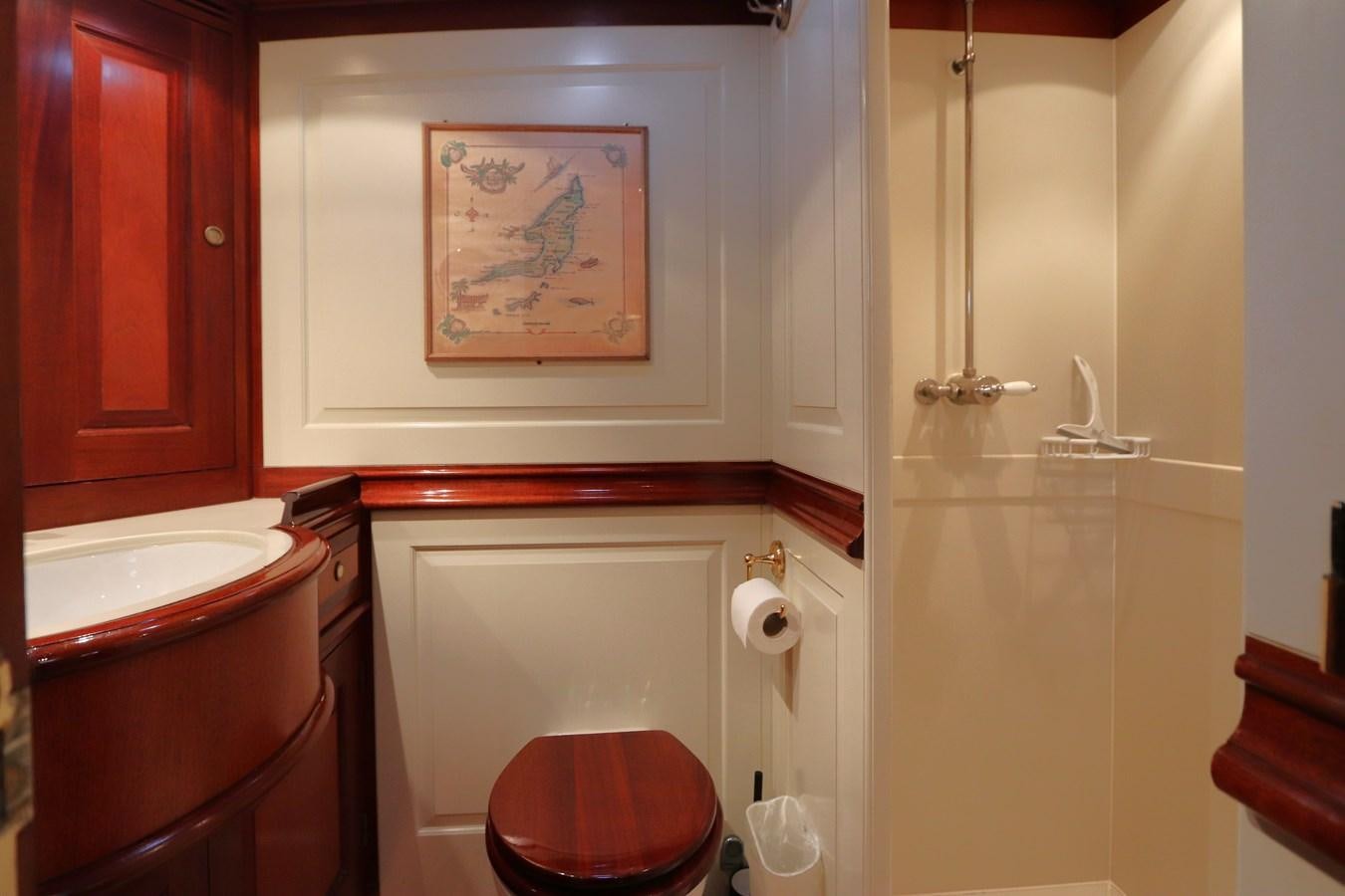 a bathroom with a painting on the wall aboard BRAVEHEART OF SARK Yacht for Sale