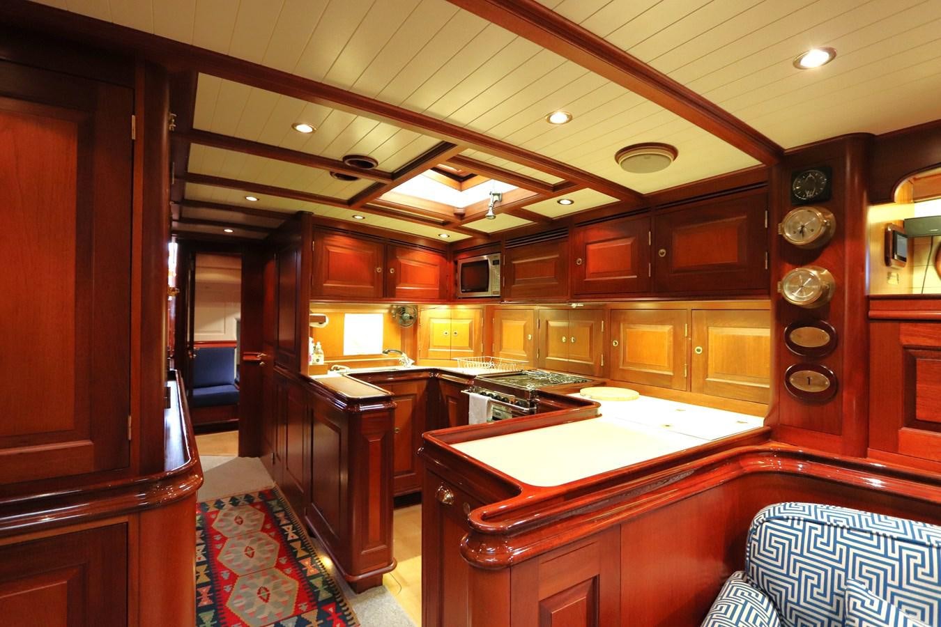 a large kitchen with wooden cabinets aboard BRAVEHEART OF SARK Yacht for Sale