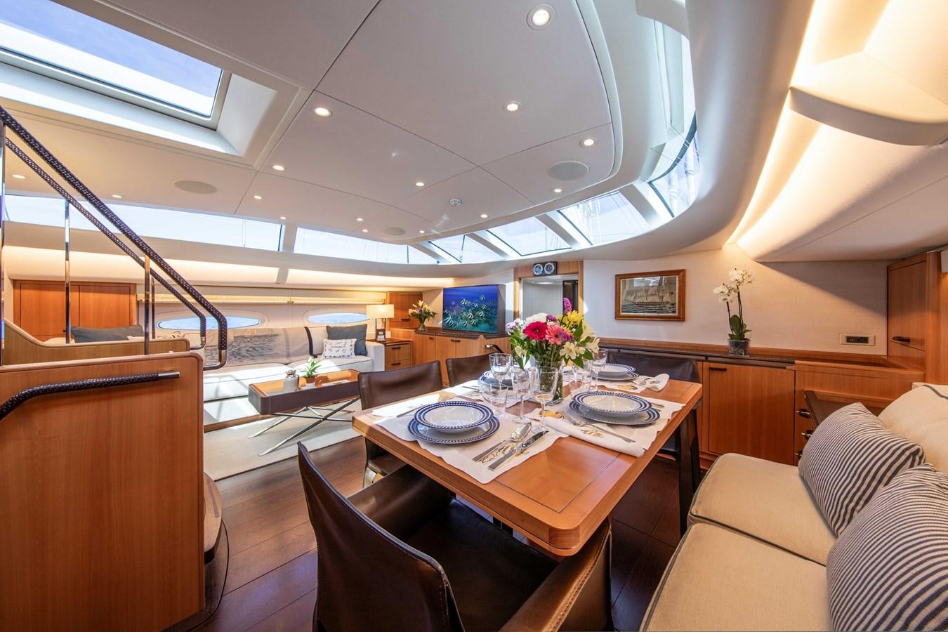 a room with a table and chairs aboard MINI Y Yacht for Sale