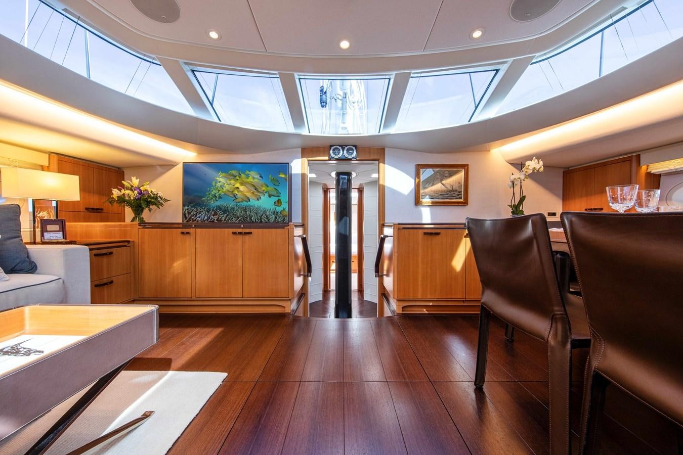 a room with a wood floor and chairs and a wood floor aboard MINI Y Yacht for Sale