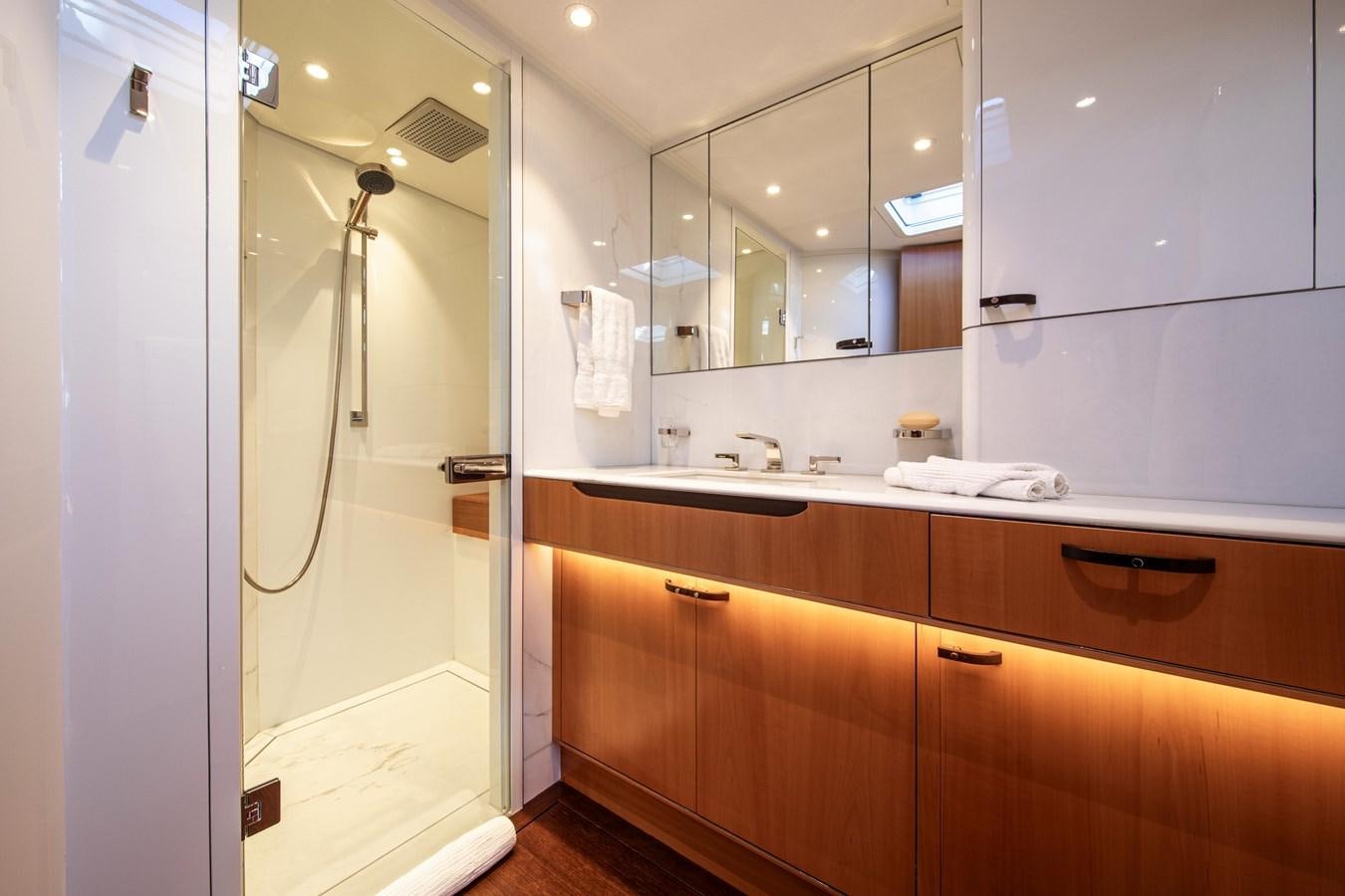 a bathroom with a shower unit and sink aboard MINI Y Yacht for Sale