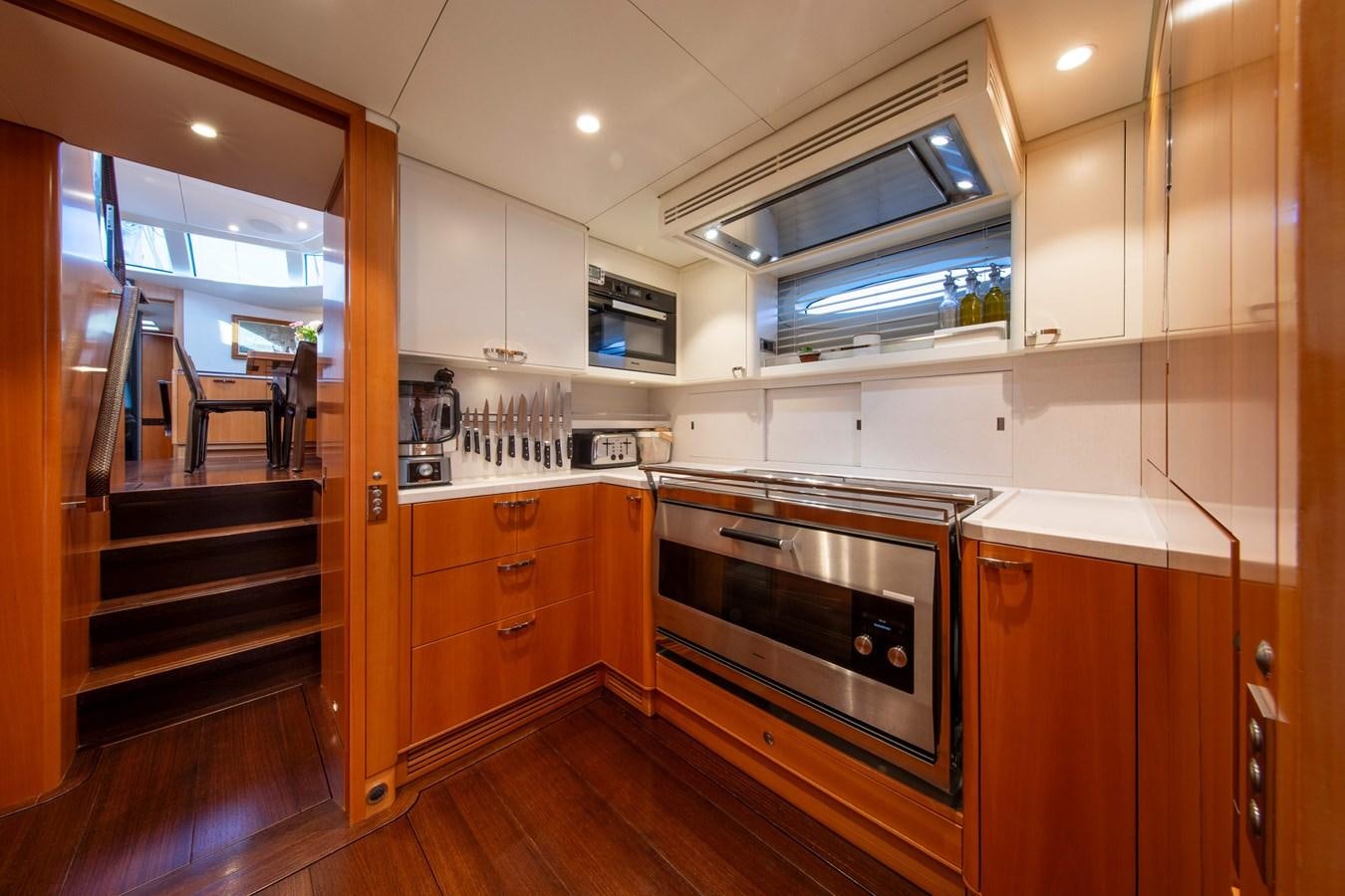 a kitchen with wooden cabinets aboard MINI Y Yacht for Sale