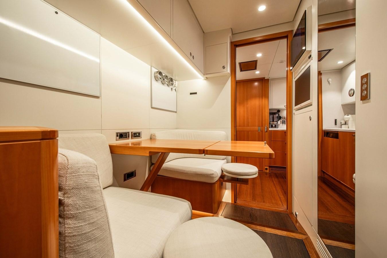 a room with a couch and a table aboard MINI Y Yacht for Sale