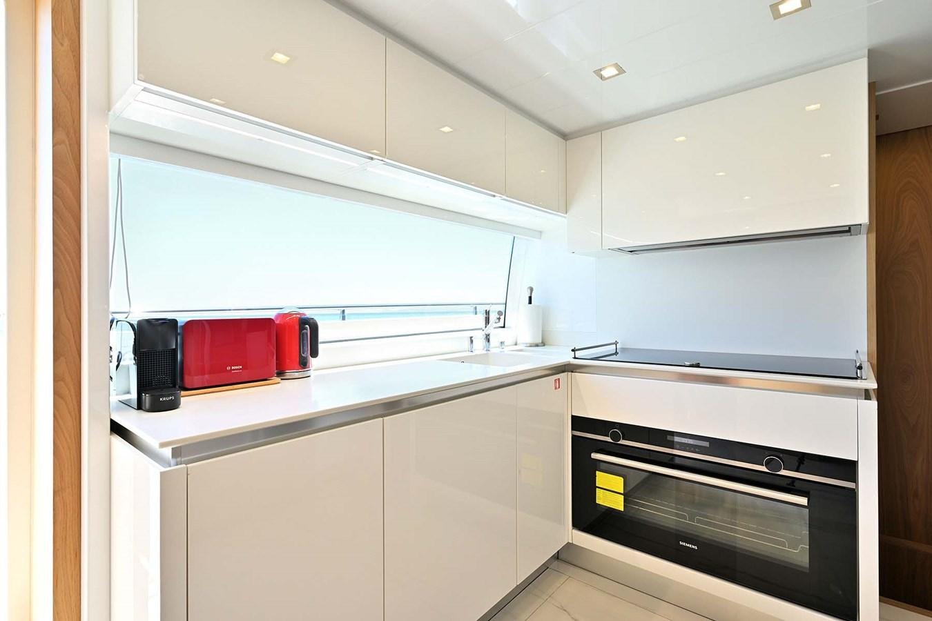 a kitchen with a microwave oven aboard HULL 21 Yacht for Sale