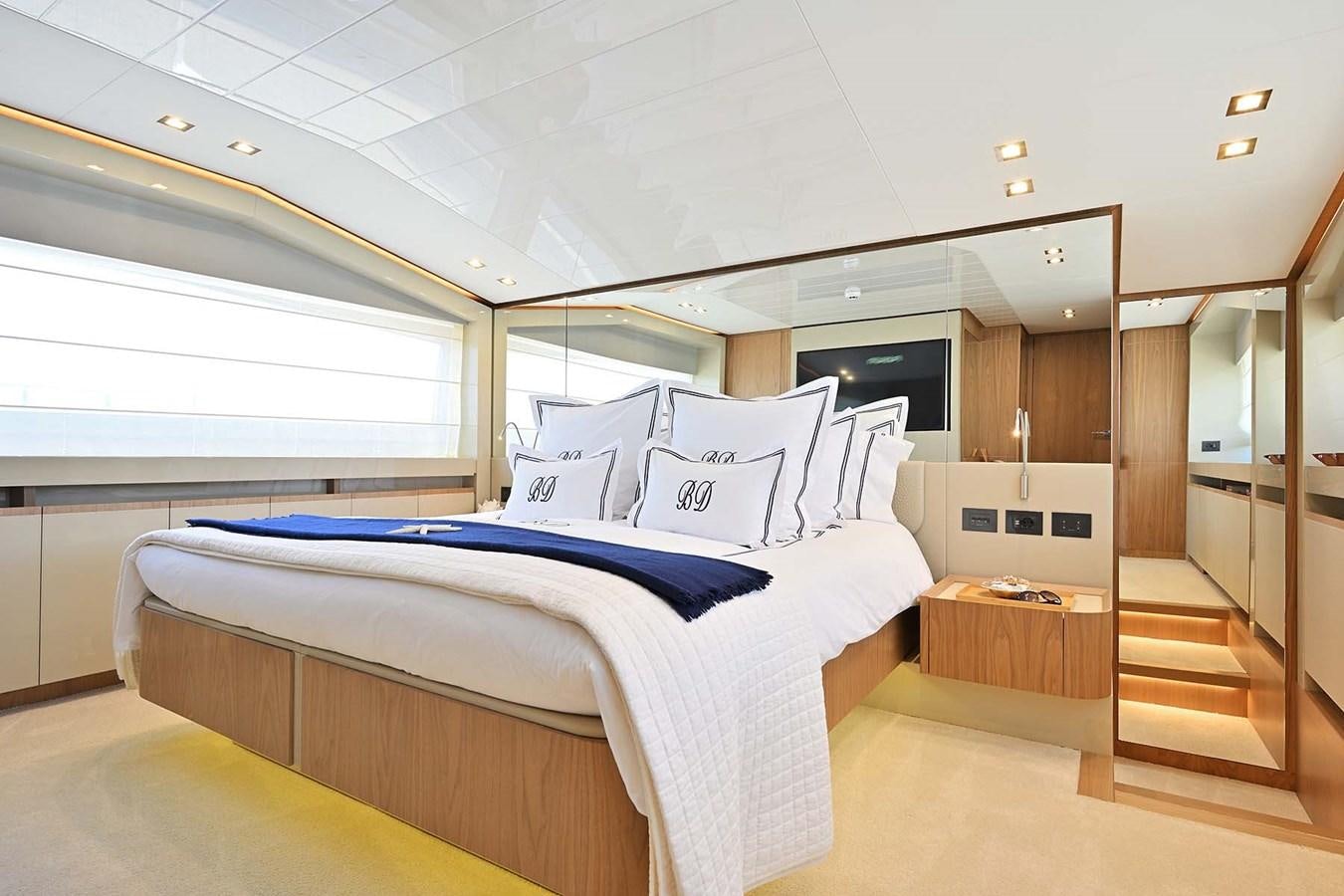 a bedroom with a bed and a wood door aboard HULL 21 Yacht for Sale