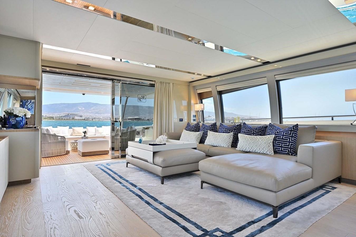 a living room with a large blue rug and white couches aboard HULL 21 Yacht for Sale