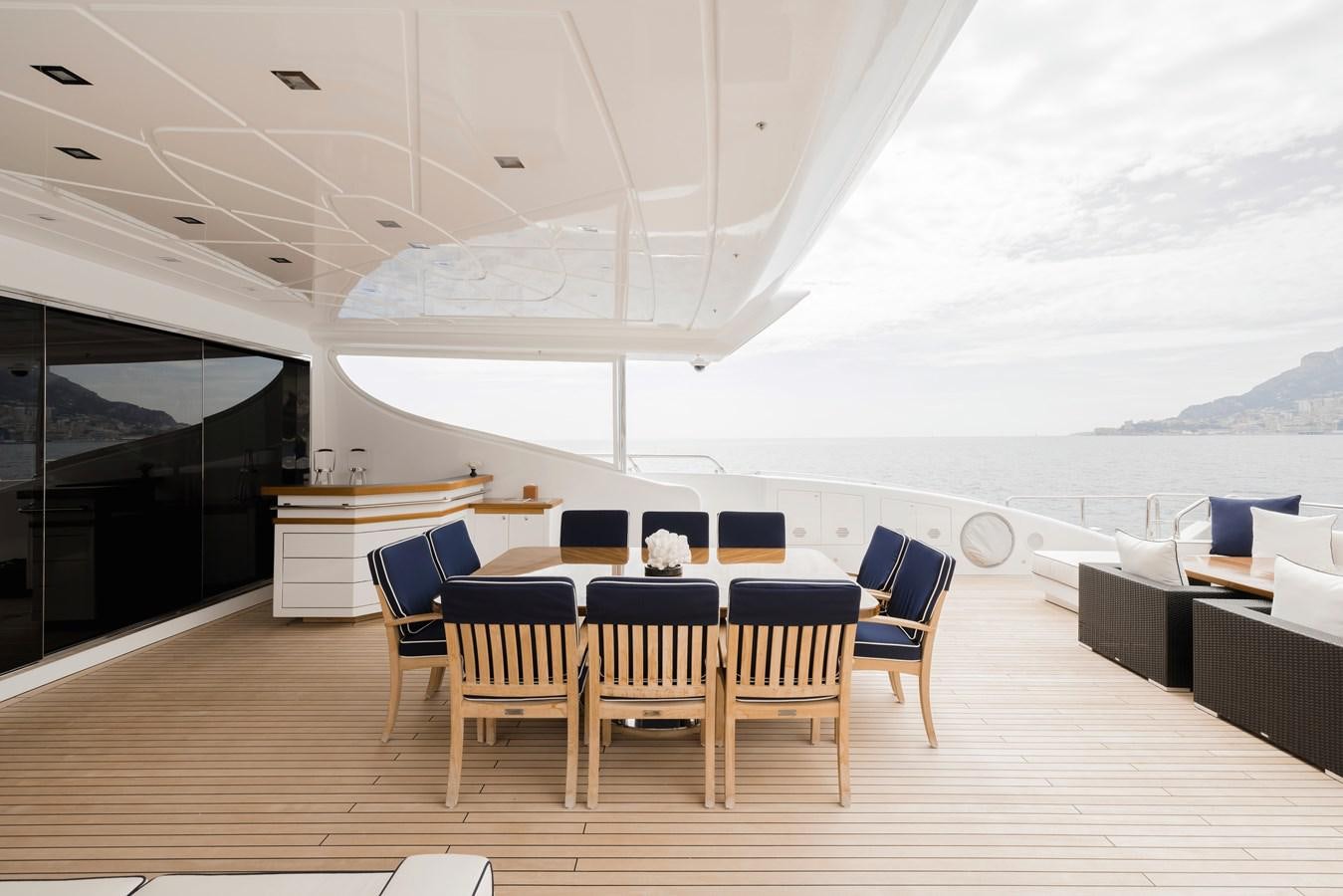 a room with a table and chairs aboard ROYALE X Yacht for Sale