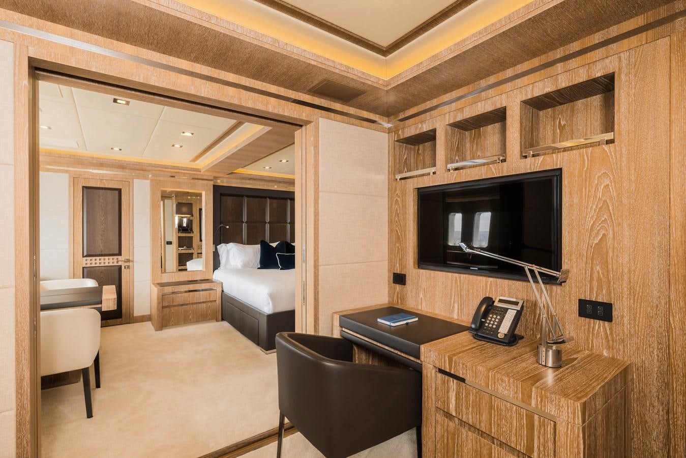 a room with a tv and a bed aboard ROYALE X Yacht for Sale