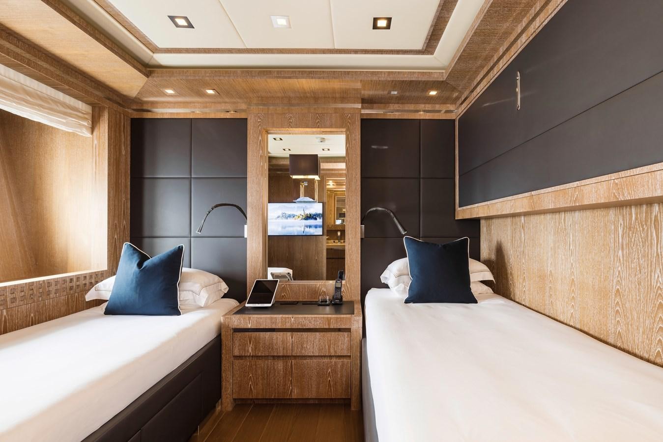 a room with a bed and a mirror aboard ROYALE X Yacht for Sale
