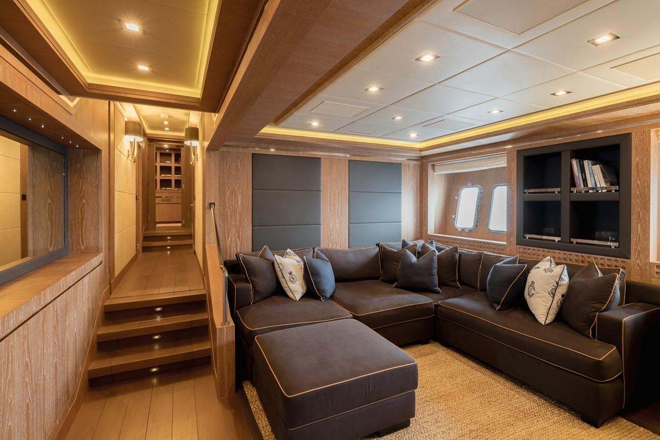 a living room with a leather couch aboard ROYALE X Yacht for Sale