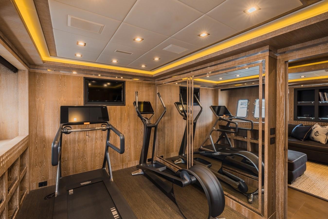 a room with a large mirror and a couch aboard ROYALE X Yacht for Sale