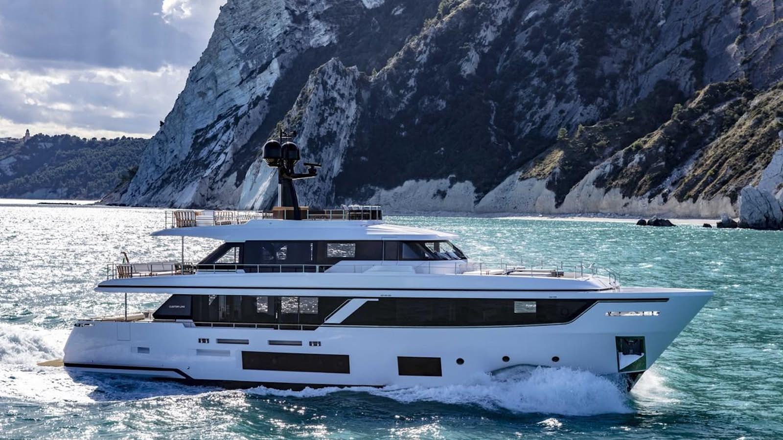 a person standing on a boat in the water aboard CUSTOM LINE NAVETTA 33/33 Yacht for Sale