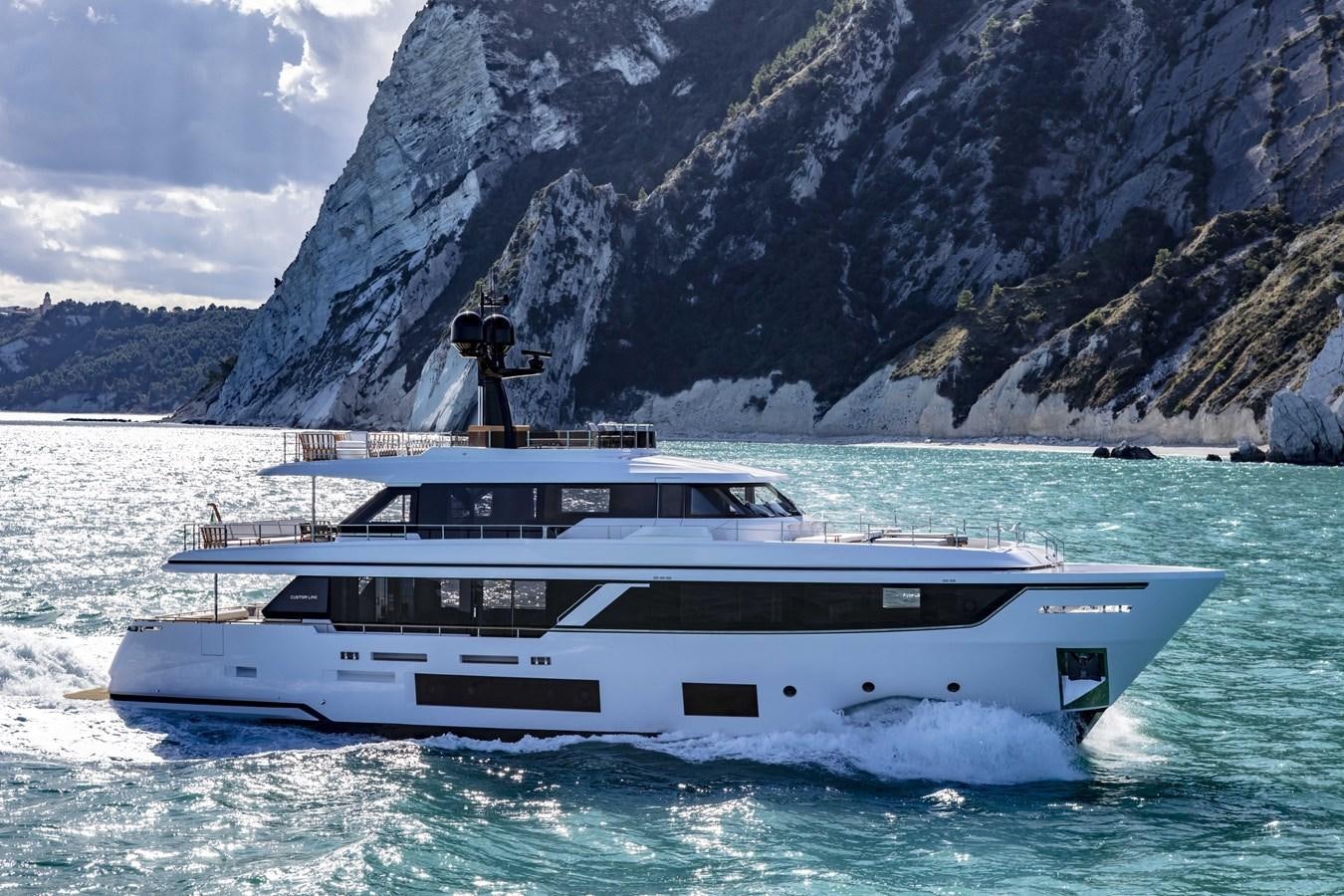 a person standing on a boat in the water aboard CUSTOM LINE NAVETTA 33/33 Yacht for Sale