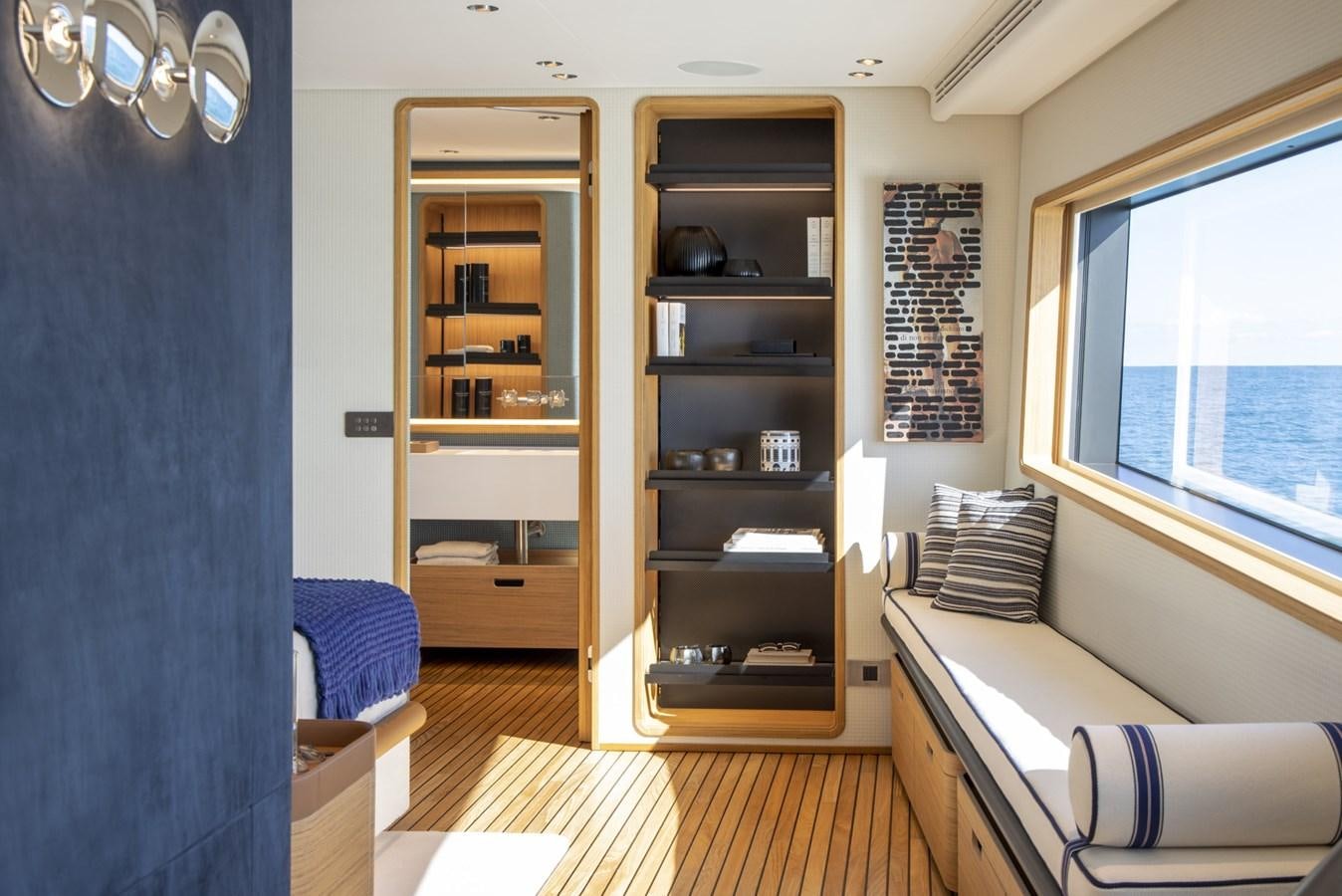 a living room with a bookcase aboard CUSTOM LINE NAVETTA 33/33 Yacht for Sale